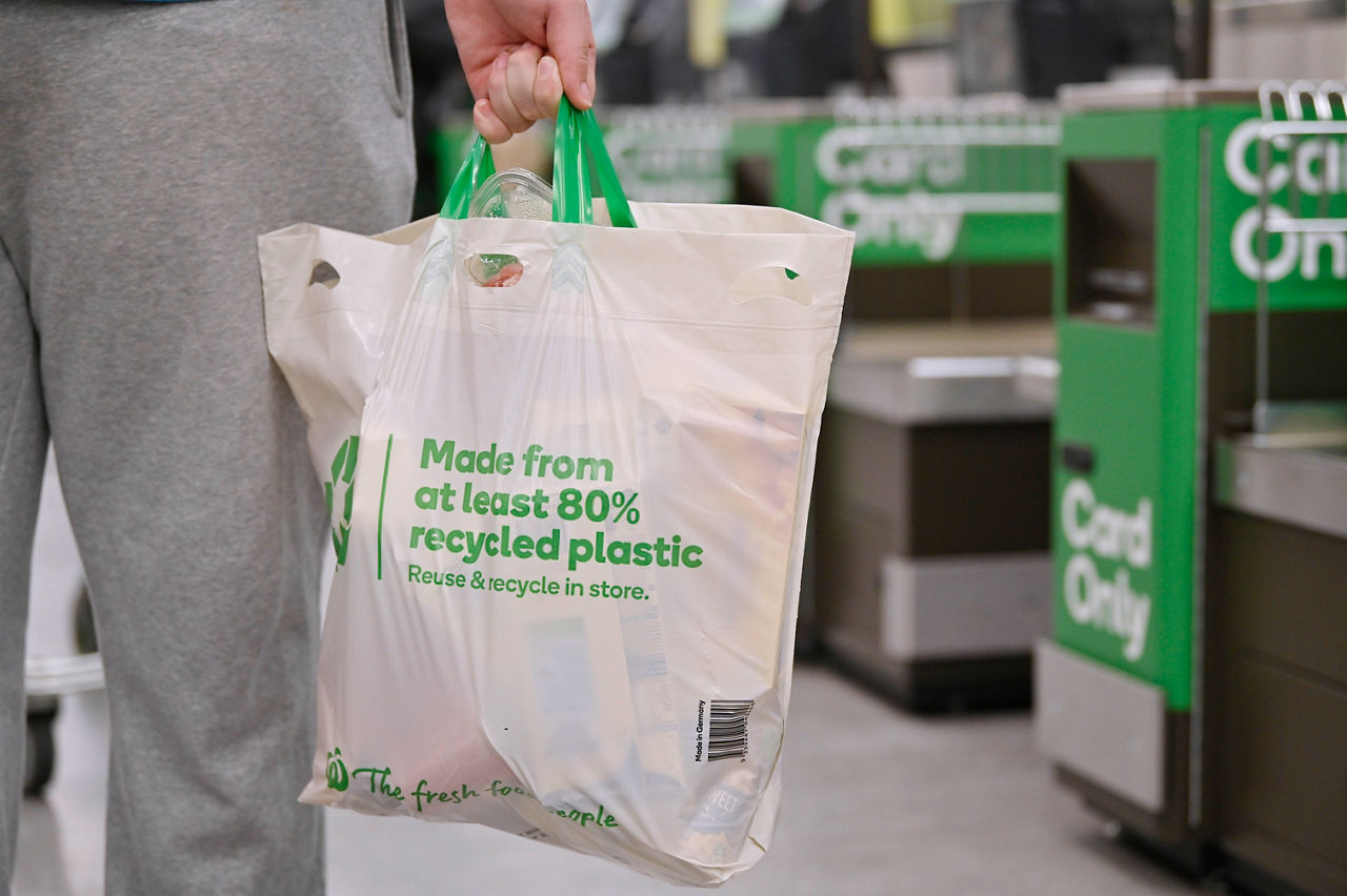 man holding plastic bag