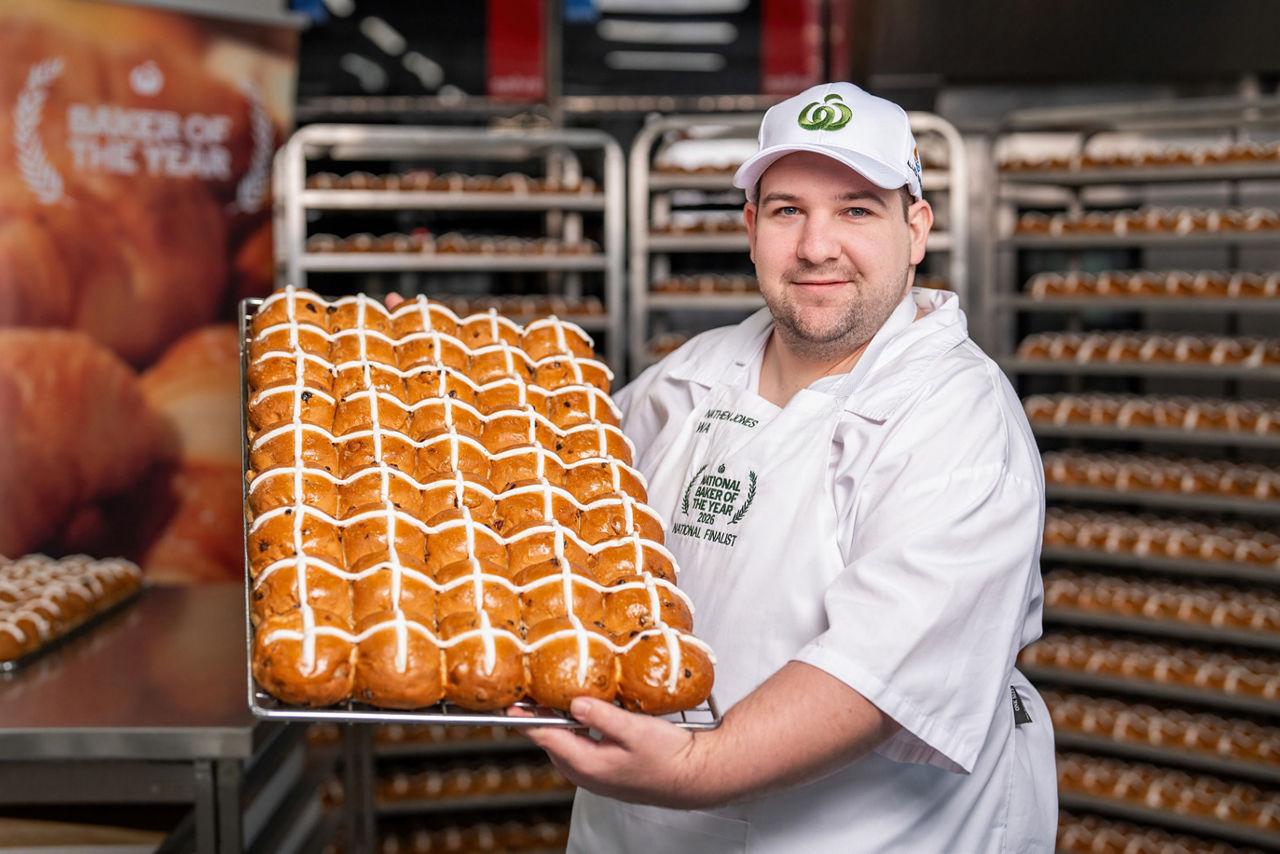 Baker presenting hot cross bun selection