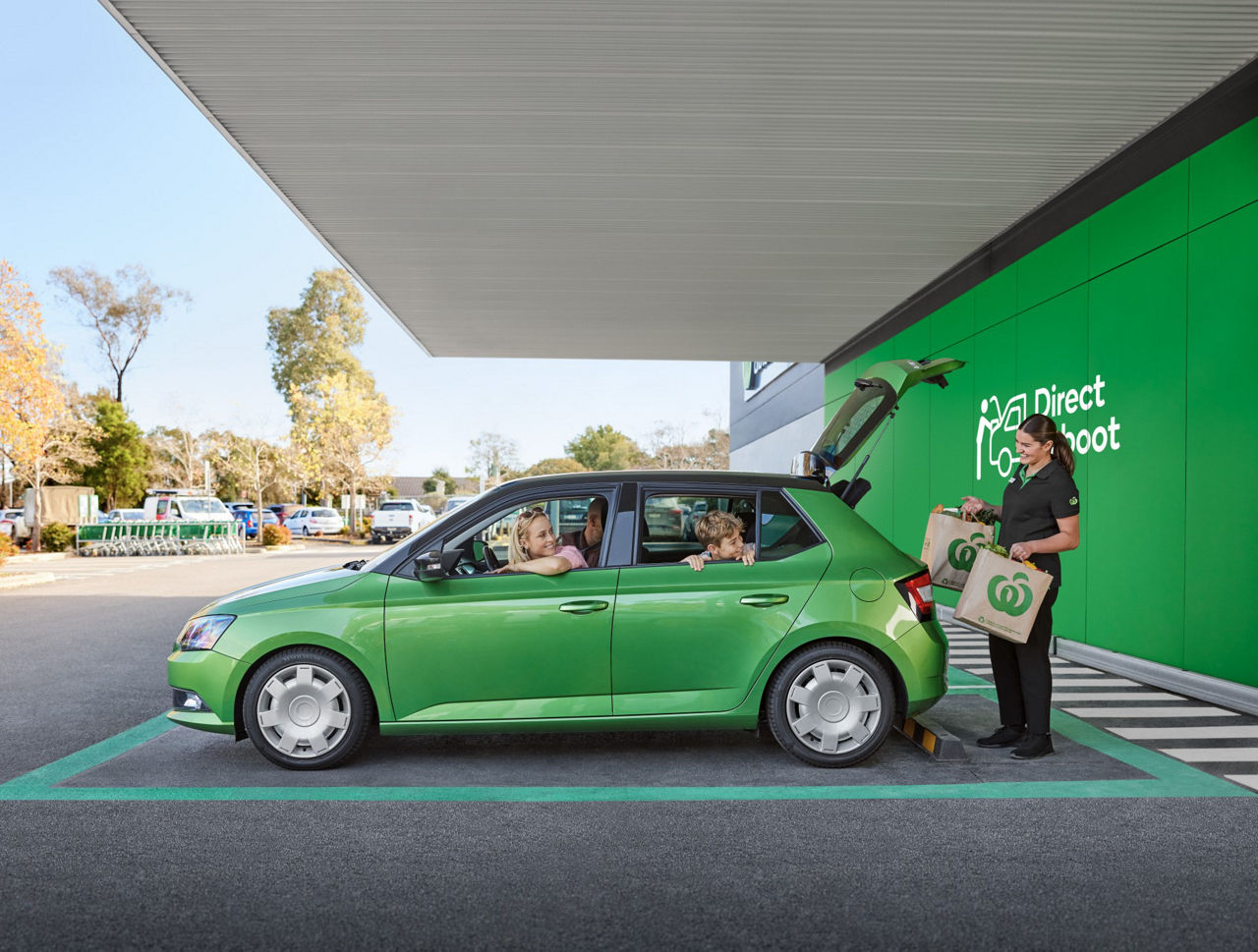 Team member loads groceries into car