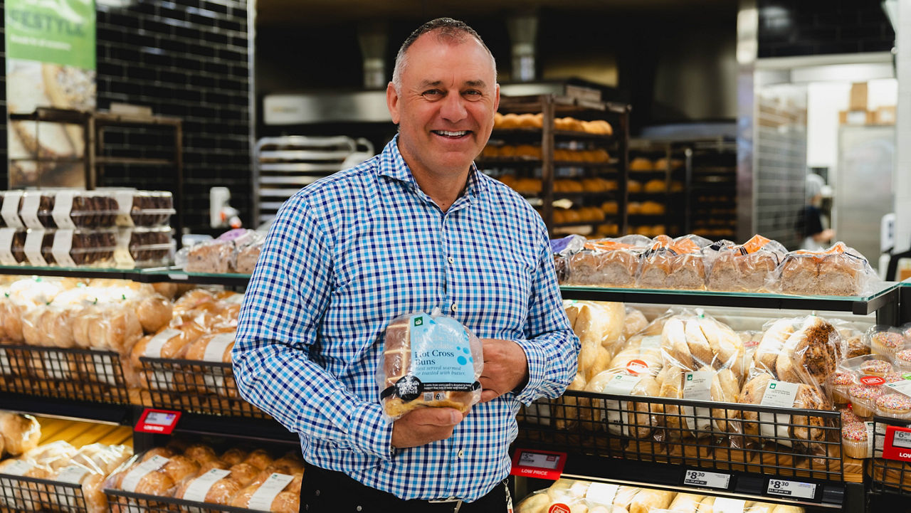 Hot cross bun expert Michael holding hot cross buns