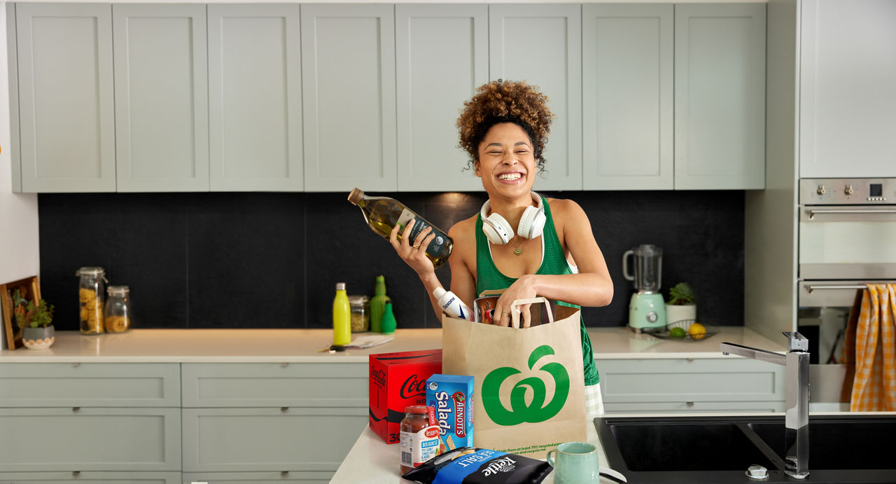 Photo of woman with Lower Shelf Price products and groceries