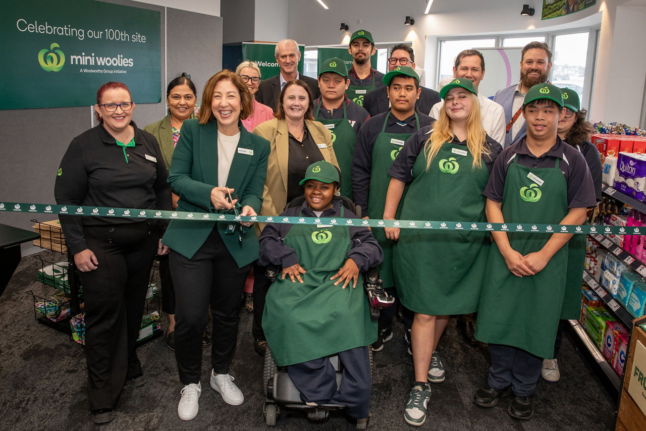 Students and guests cutting the ribbon at a launch