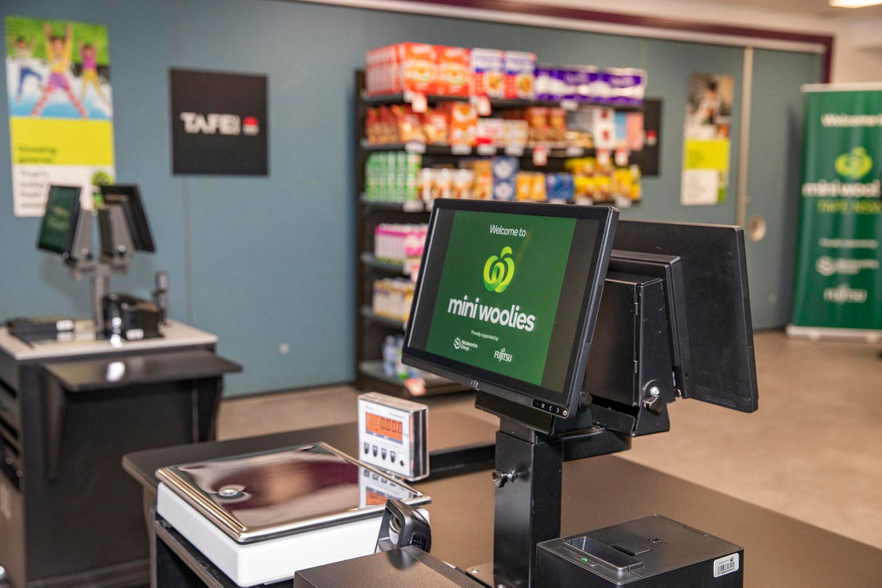 Supermarket checkout with shelves in background