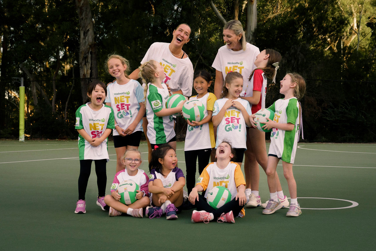 Young netball players on court