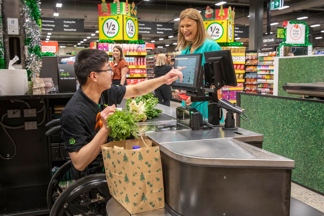 Johnson Chen serving his first customer at the new wheelchair accessible checkout