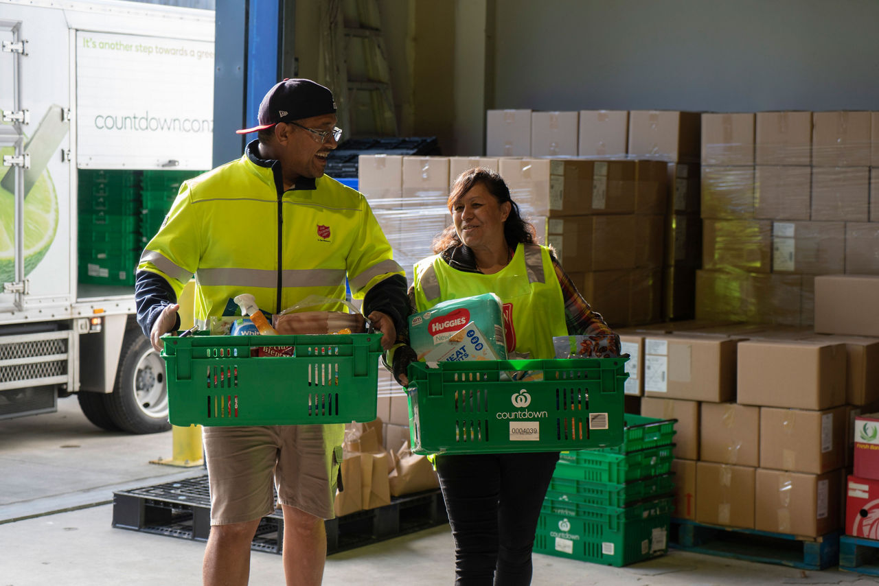 Countdown team member and The Salvation Army carry groceries