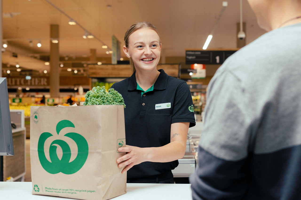 A woman at the checkout serving a customer