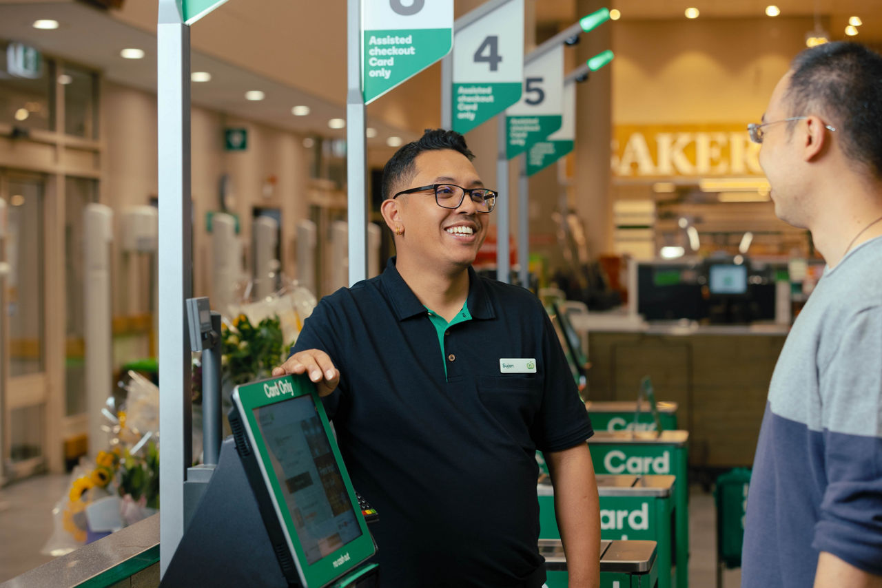 Staff member helping a customer at the self-service register