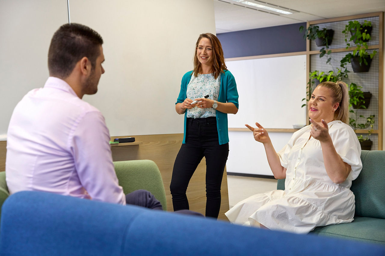 Staff members sitting in a room and talking