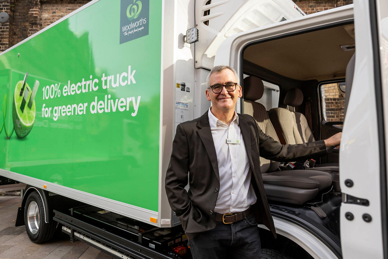 Woolworths CEO standing at door of electric deliervy truck