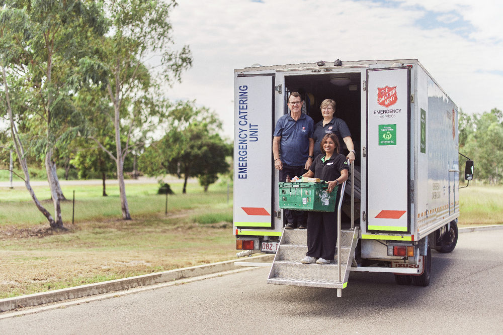 Salvation Army truck with Woolworths and Salvation Army team members