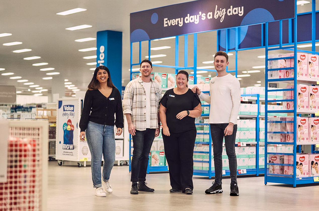 Team members standing and smiling together in a store